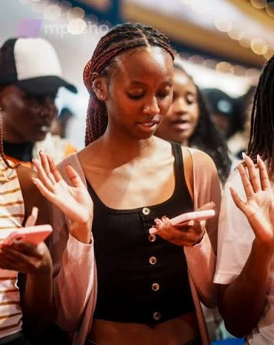Kingdom Foundation College students raising their hands during a class
